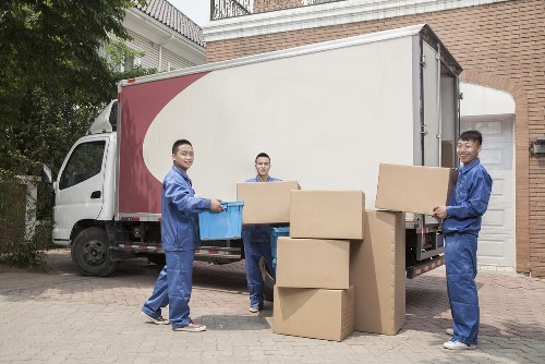 Furniture removals team handling household items in Holland Park