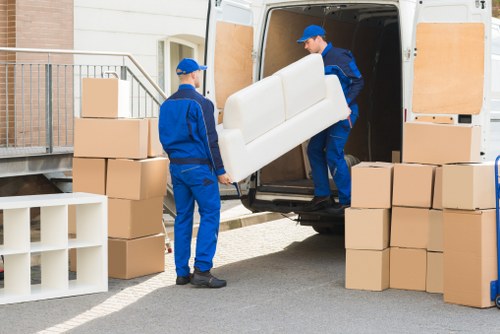 Mover loading furniture carefully into a removal vehicle