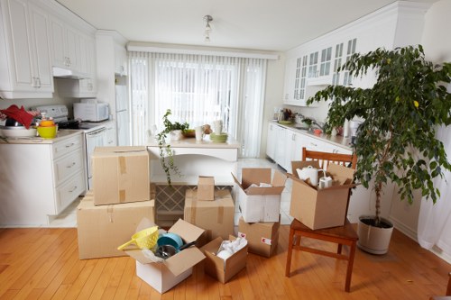 Furniture and boxes being carried from a flat in Holland Park