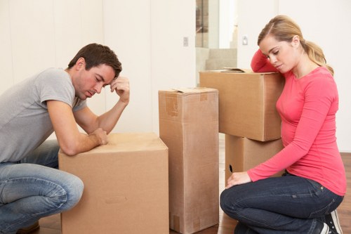 Movers carefully handling a heavy item with proper technique