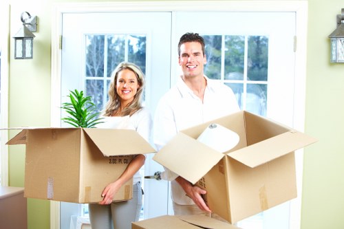 Organised moving boxes labelled for rooms in a Holland Park home