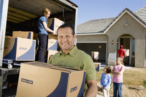Packed boxes and furniture ready for transport by removals crew